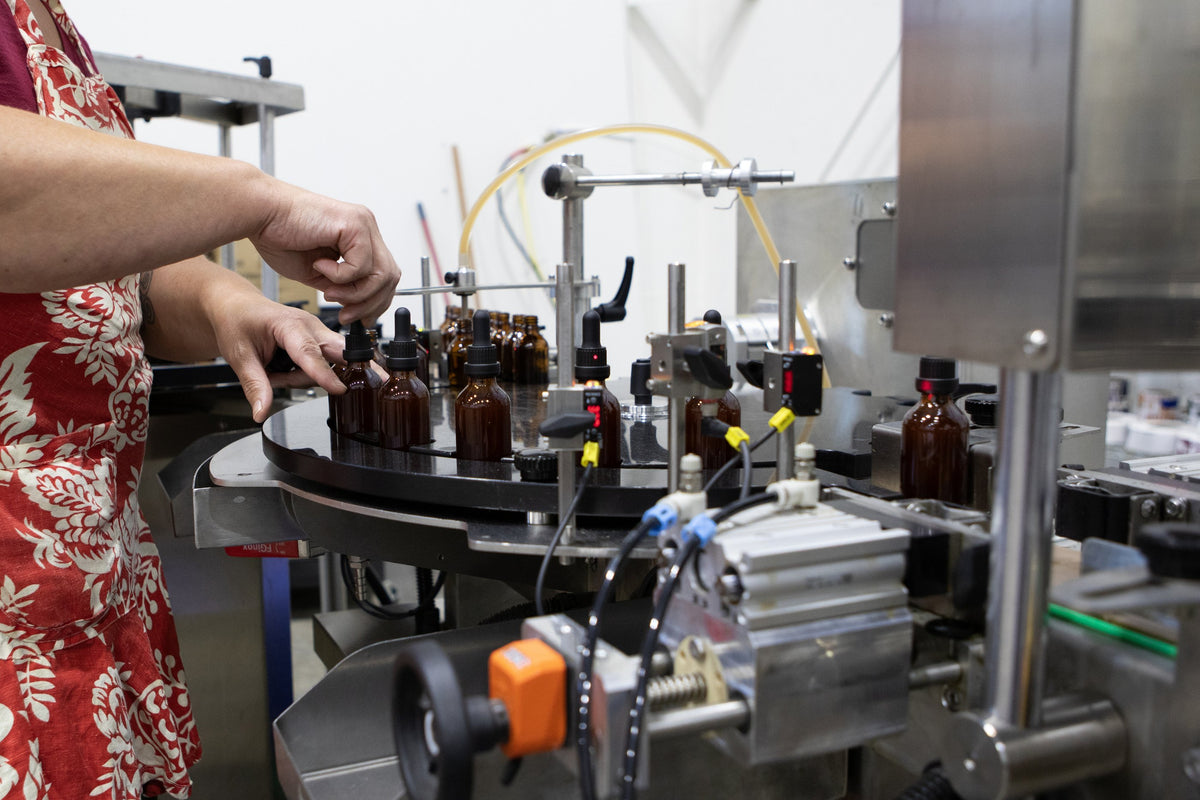 Bottling line filling amber Feral Fungi tincture bottles